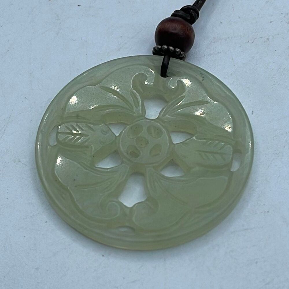 Hand carved light green Xiuyu jade floral design .